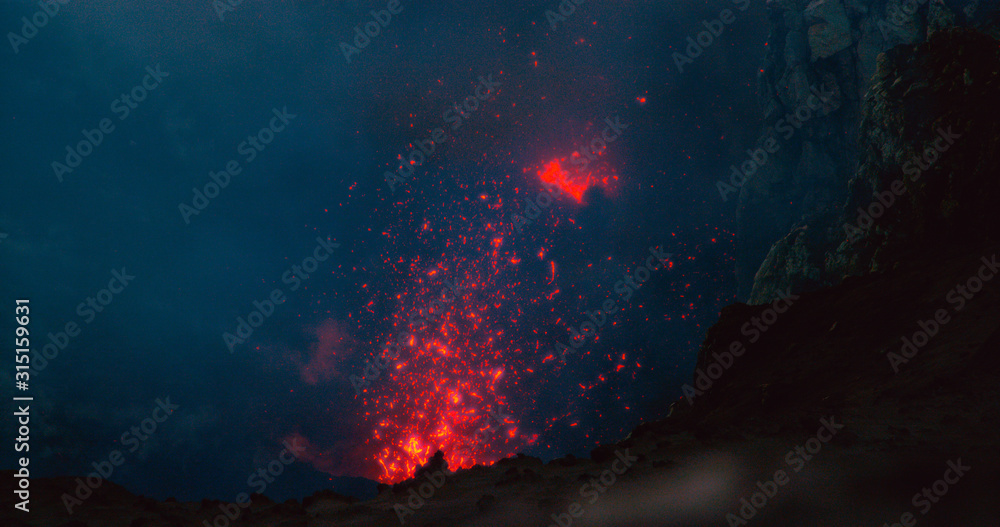 CLOSE UP: Glowing hot magma bursting out of the volcanic crater in Vanuatu.