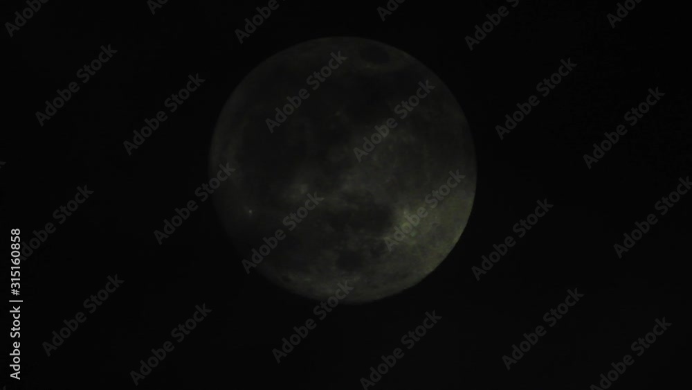 Clouds passing by moon at night. Full moon at night with clouds in real time. Clouds passing by moon at night. Full moon at night with clouds in real time.
