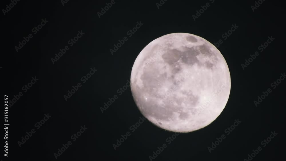 Clouds passing by moon at night. Full moon at night with clouds in real time. Clouds passing by moon at night. Full moon at night with clouds in real time.