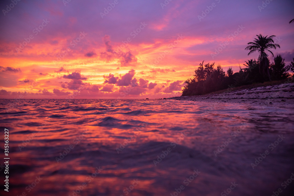 Tropical pink and purple sunset over ocean
