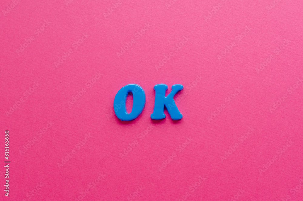 ok from plastic magnets on paper background ok from plastic magnets on paper background