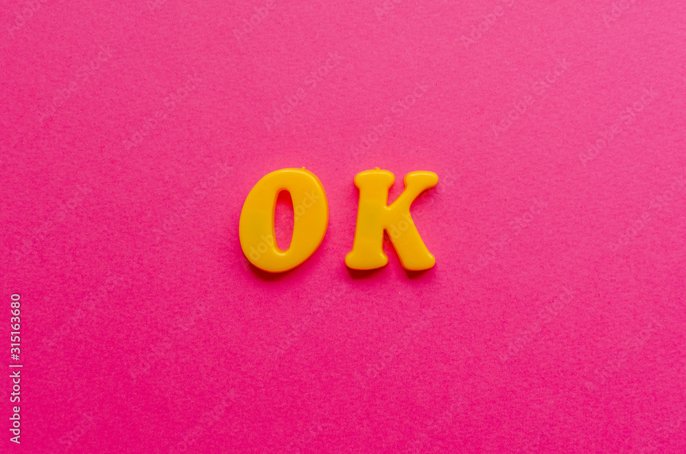 ok from plastic magnets on paper background ok from plastic magnets on paper background