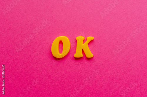 ok from plastic magnets on paper background