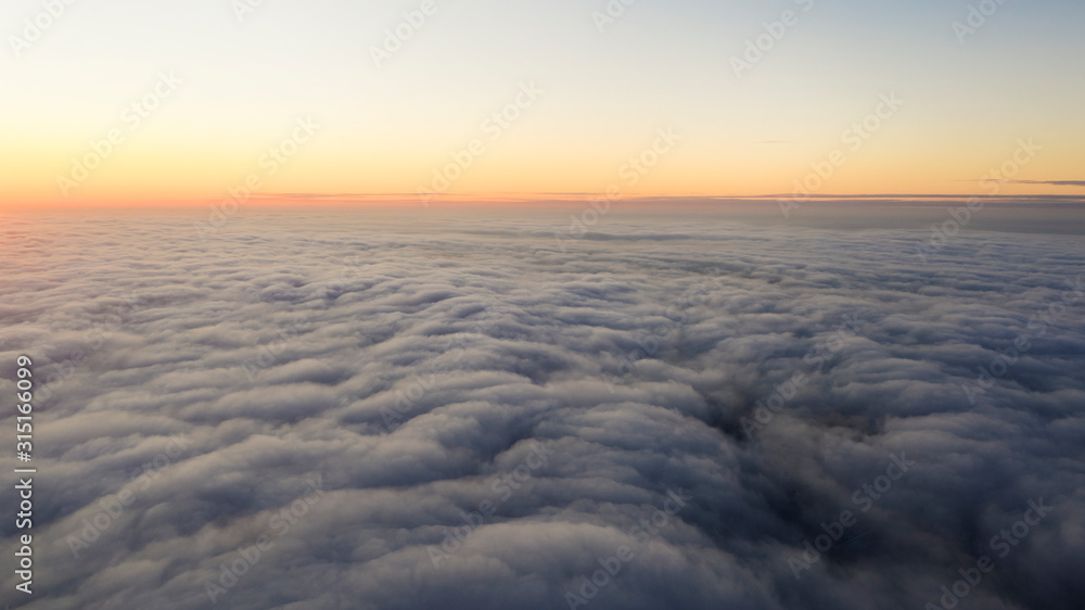 Yellow and blue dawn over clouds, concept, travel and leisure. Yellow and blue dawn over clouds, concept, travel and leisure.