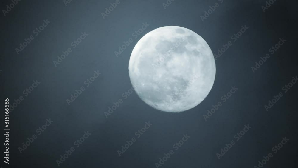 Clouds passing by moon at night. Full moon at night with clouds in real time. Clouds passing by moon at night. Full moon at night with clouds in real time.