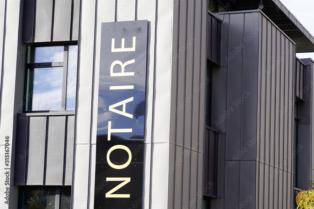 office entrance board notary in modern building french Notaire office entrance board notary in modern building french Notaire