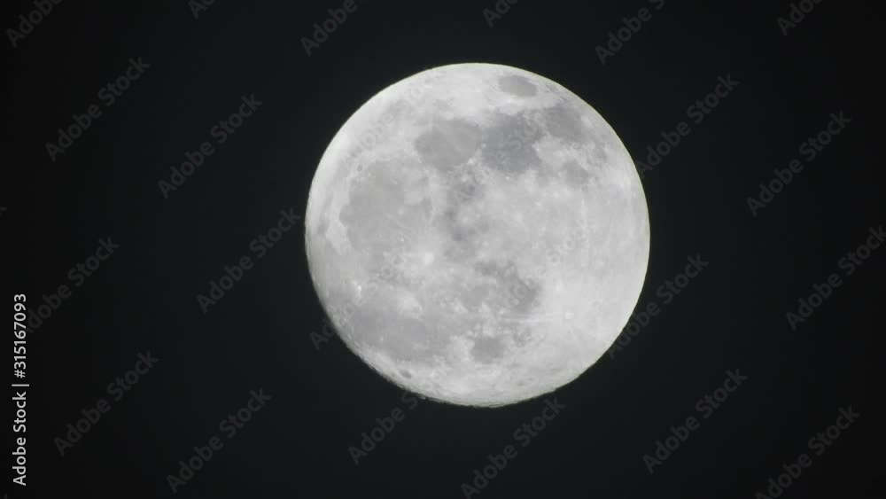 Clouds passing by moon at night. Full moon at night with clouds in real time. Clouds passing by moon at night. Full moon at night with clouds in real time.