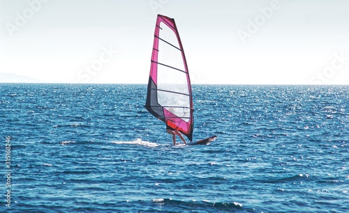 Windsurfing on blue sea © disq