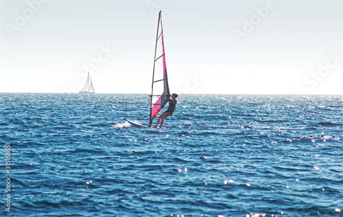 Windsurfing on blue sea