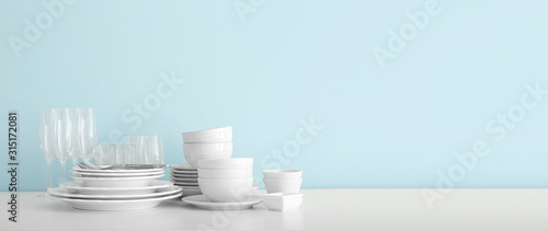 Set of clean dishware on table with space for text photo