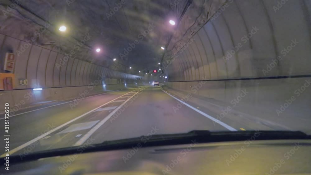 A drive in an amazing constructed and wide tunnel of Mallorca, Spain, with beautiful street lights and street signs. A drive in an amazing constructed and wide tunnel of Mallorca, Spain, with beautiful street lights and street signs.