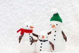 Toy snowman family on white background