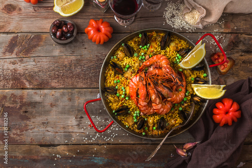Large pan of paella with seafood and vegetables, copy space photo