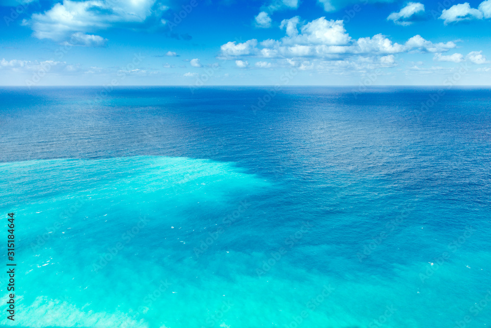 Clear sea with several shades of blue under azure sky