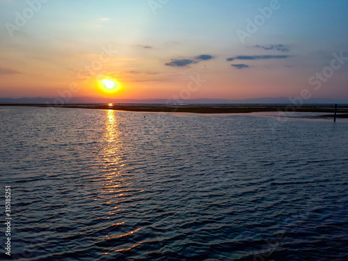 Fototapeta Naklejka Na Ścianę i Meble -  Bright sunset above adriatic sea in Grado, Italy