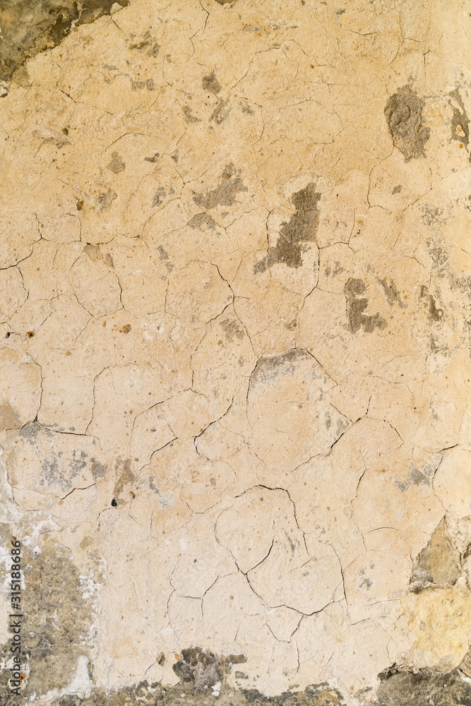 an empty background of cracked creme concrete that is worn down or weathered showing texture with copy space or space for tekst