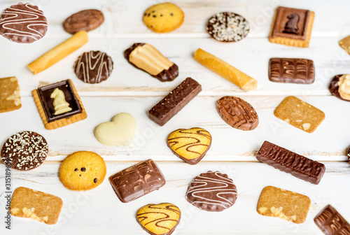 Many Different Biscuits on a White Wooden Background © boryanam