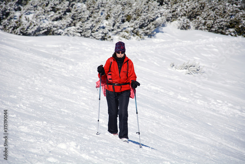 Hiker Woman   in the High Snowy Mountain .Winter Vacation Concept 