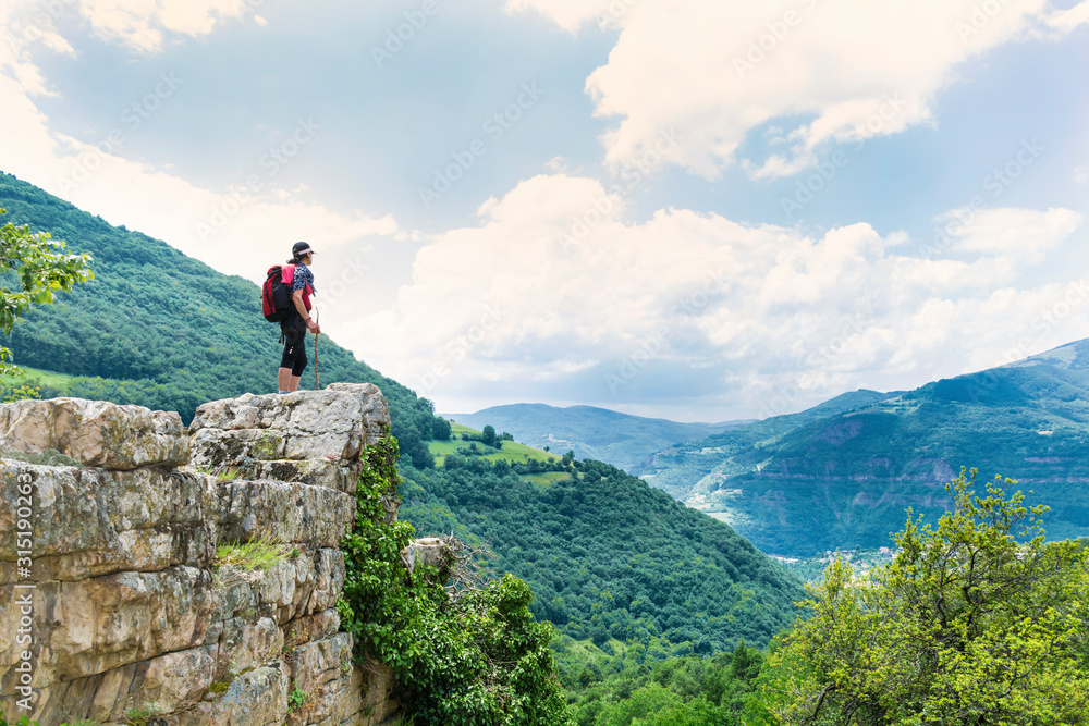 Woman Standing on a Rocks in  the High Mountain with Stunning  Panoramic View