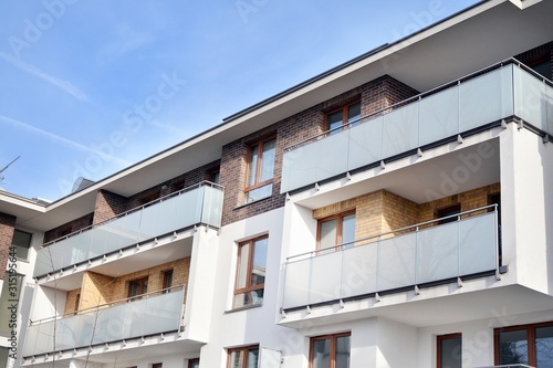 Modern apartment buildings on a sunny day with a blue sky. Facade of a modern apartment building.Glass surface with sunlight.