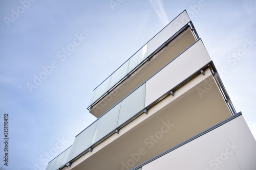 Modern apartment buildings on a sunny day with a blue sky. Facade of a modern apartment building.Glass surface with sunlight.