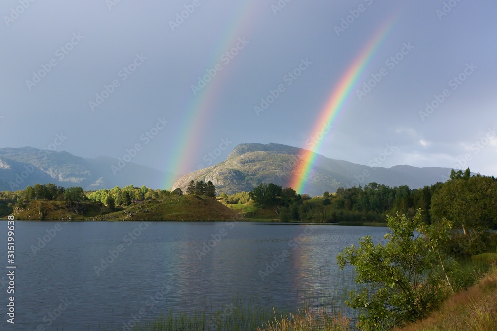 A double rainbow above norwegiean mountain and lake A double rainbow above norwegiean mountain and lake