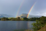 A double rainbow above norwegiean mountain and lake