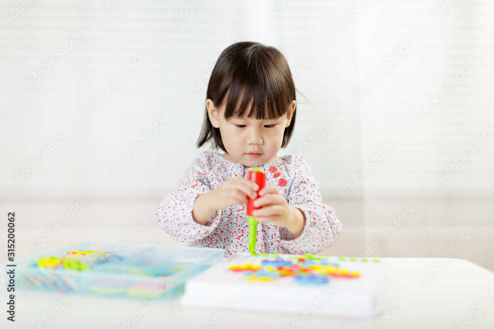 toddler girl playing creative toy blocks at home against white background toddler girl playing creative toy blocks at home against white background