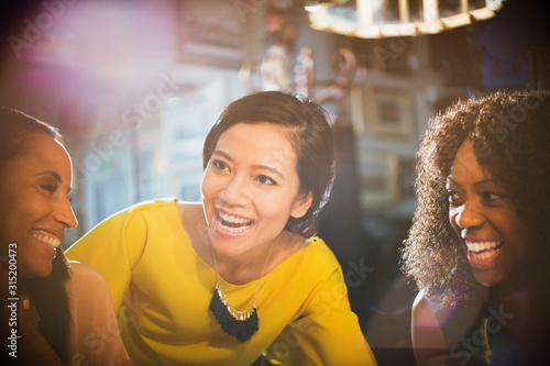 Wallpaper Mural Smiling women laughing and talking in restaurant Torontodigital.ca