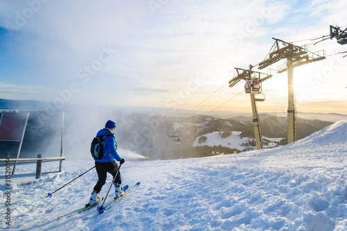 Male skier skiing on ski slope at Donovaly ski resort in Slovakia photo