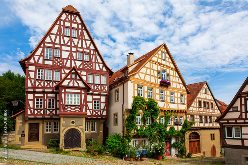 Historic, medieval half-timbered houses. The old German city of Bad Wimpfen in Baden-Württemberg, Germany. Summer photo on a sunny day against a bright blue sky