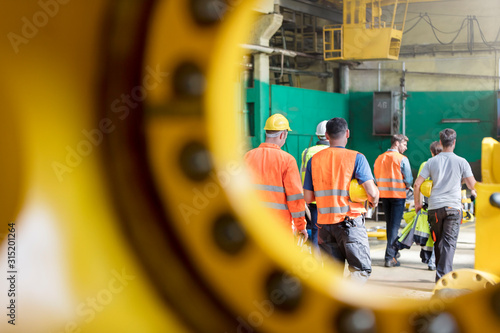 Steel workers walking in factory
