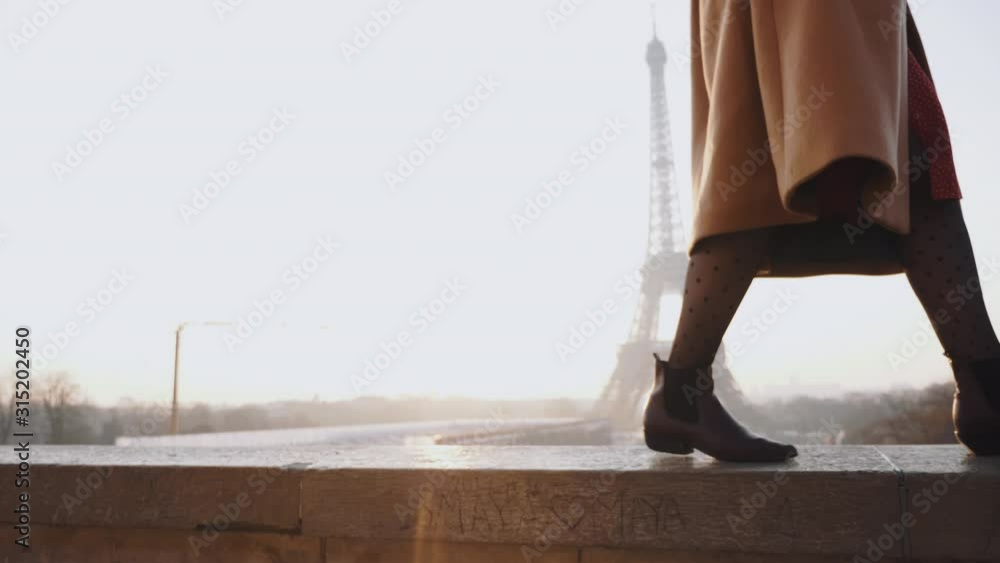 Cinematic move on legs of beautiful happy tourist woman walking, smiling at romantic Eiffel Tower in Paris slow motion. Cinematic move on legs of beautiful happy tourist woman walking, smiling at romantic Eiffel Tower in Paris slow motion.
