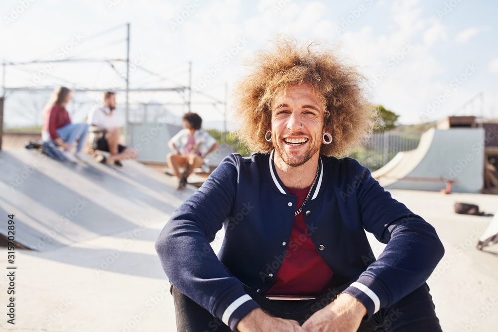 © Trevor Adeline/Caia Image - Portrait confident young man with afro at sunny skate park © Trevor Adeline/Caia Image - Portrait confident young man with afro at sunny skate park