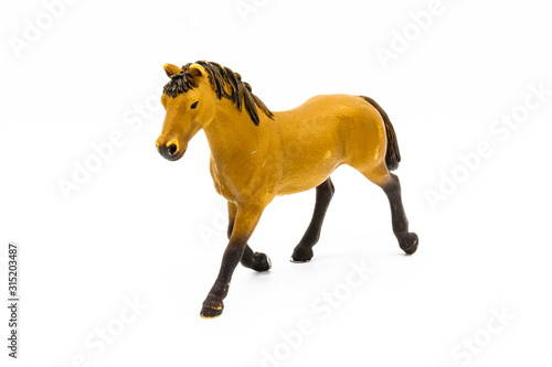 Toy brown foal isolated on white. Cute little toy horse isolated on white. Farm animals collection/Toy brown foal isolated on white.