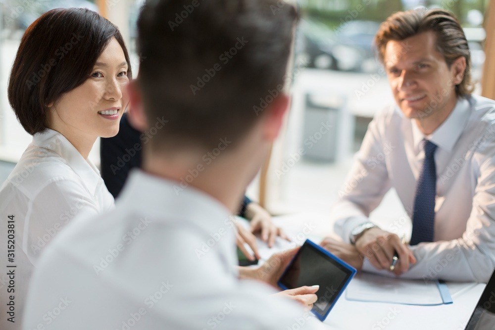 Business people with digital tablet talking in meeting Business people with digital tablet talking in meeting