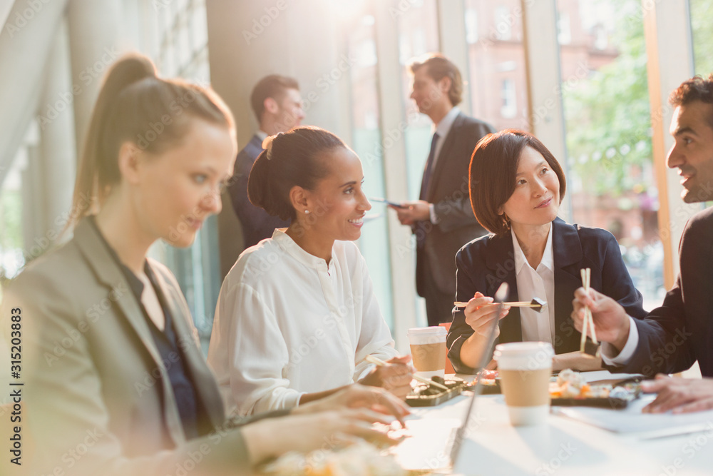 Business people eating sushi lunch chopsticks in conference room meeting Business people eating sushi lunch chopsticks in conference room meeting