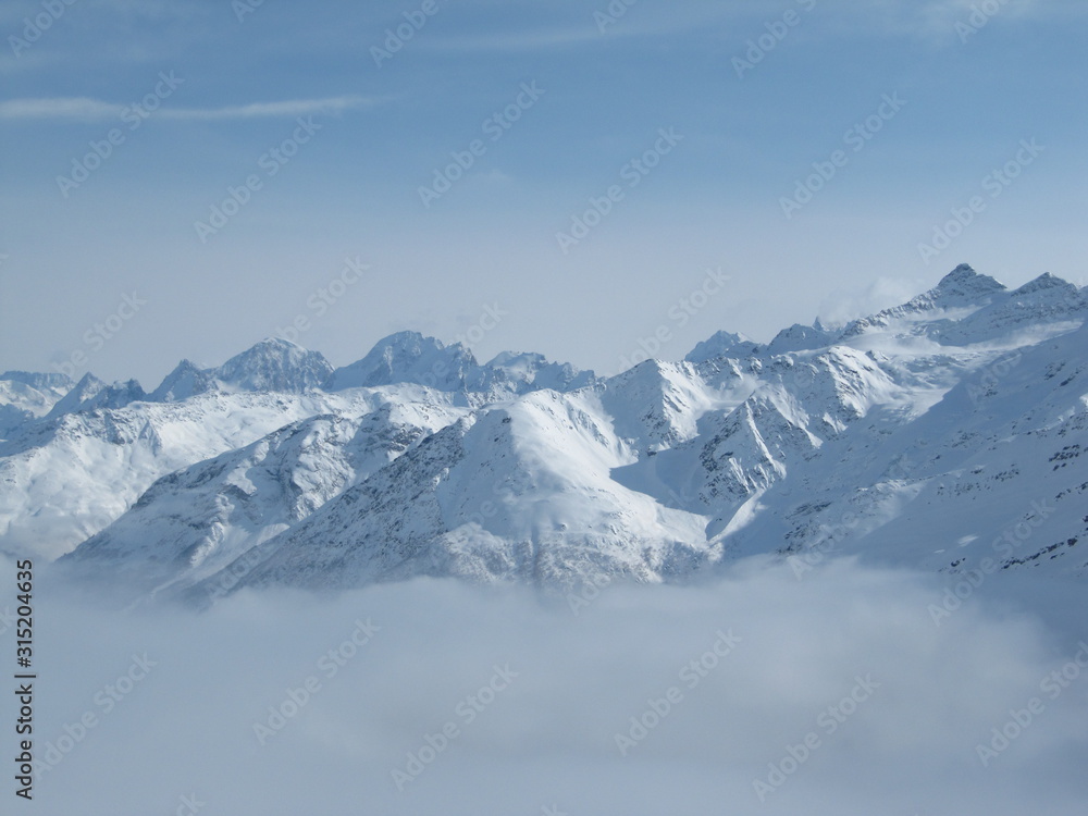 Mountain range above layer of white clouds. beautiful scenery