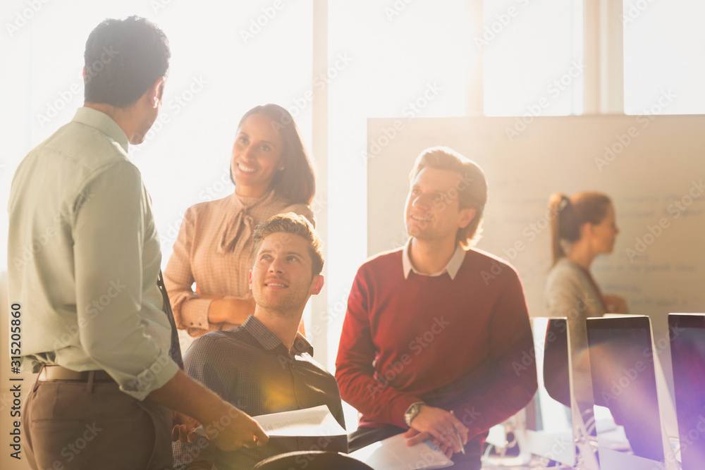 Smiling business people talking in sunny office Smiling business people talking in sunny office