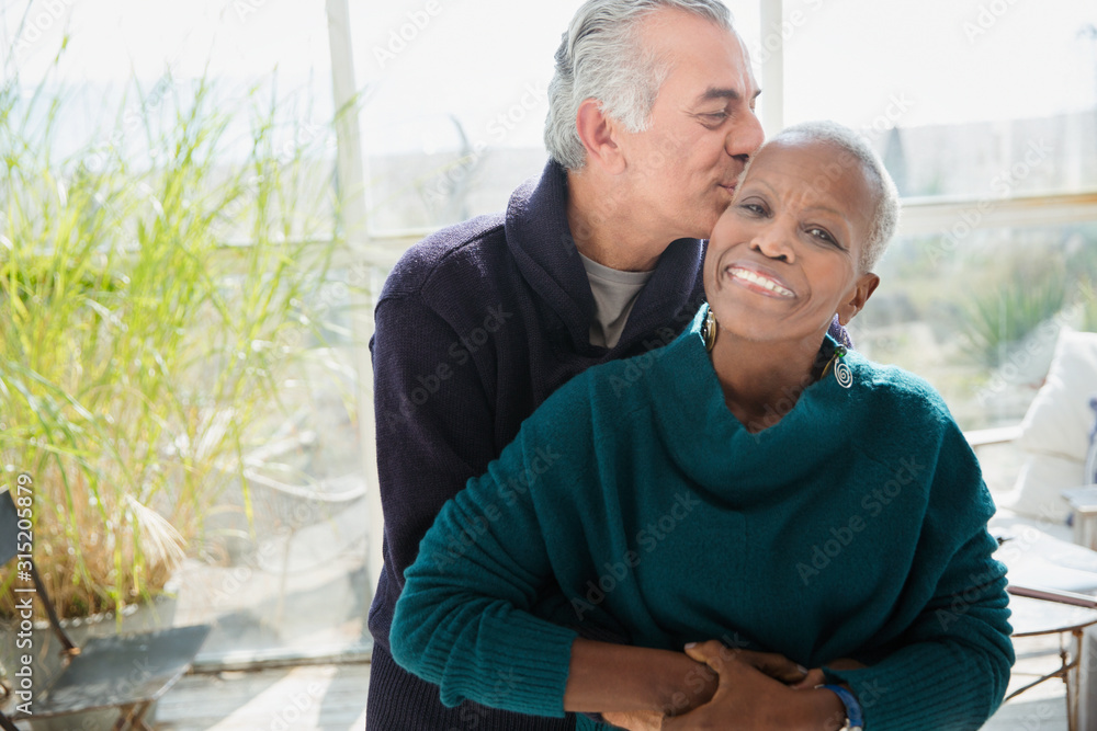 Portrait affectionate senior couple hugging and kissing Portrait affectionate senior couple hugging and kissing