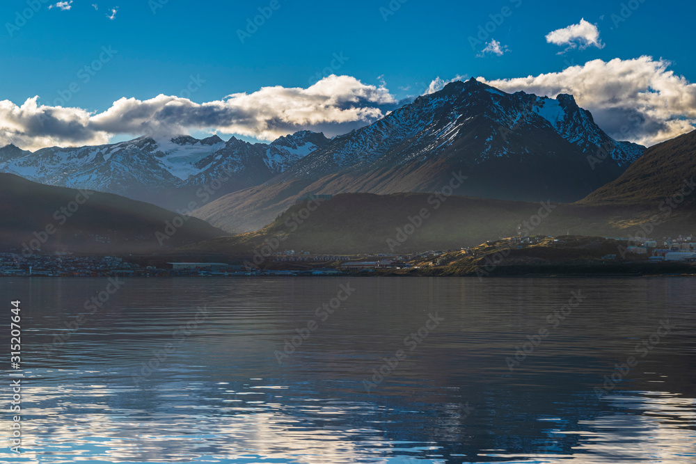 Landscape view of Ushuaia against snow capped mountains from Beagle Channel