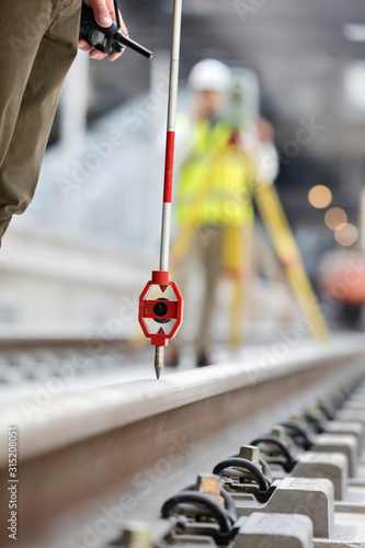 Engineers surveying tracks at construction site