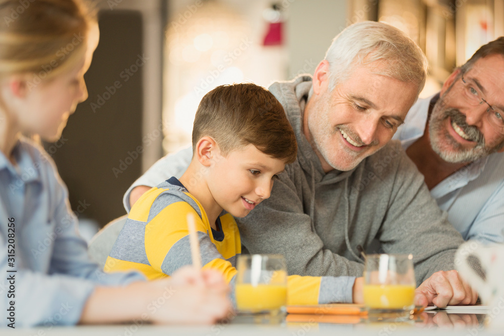 Male gay parents and children using digital tablet Male gay parents and children using digital tablet