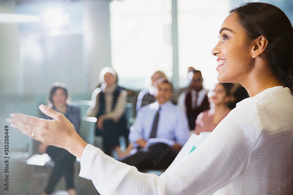 Smiling businesswoman leading conference presentation Smiling businesswoman leading conference presentation