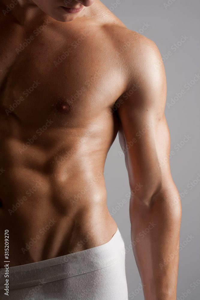 Fototapeta premium Male Fitness Model Shirtless with Defined Abs