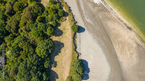 Aerial View from the Beach, Ocean, Green Trees of Wenderholm Regional Park in New Zealand - Auckland Area photo