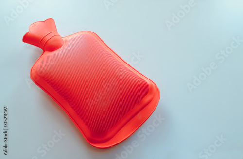 A red plastic hot water bottle