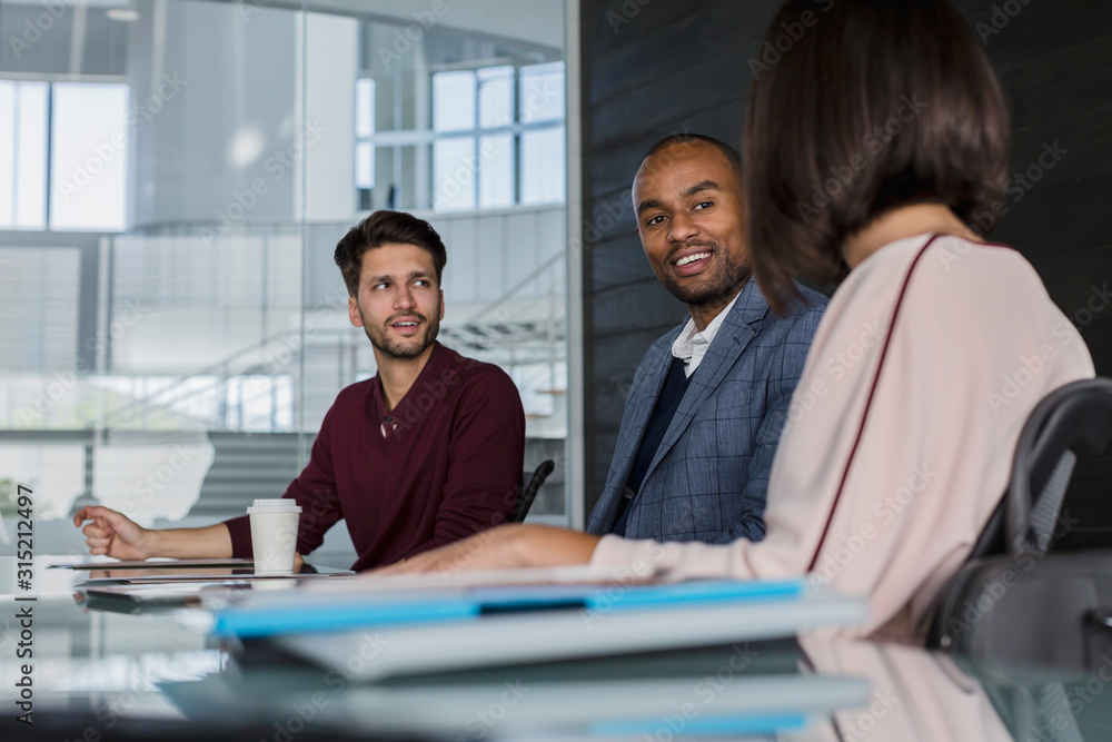 Smiling business people talking, planning in conference room meeting Smiling business people talking, planning in conference room meeting
