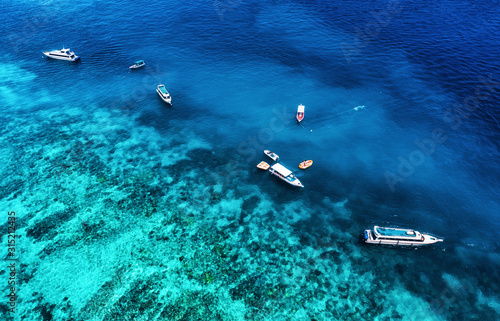Boats on the water surface from top view. Azure water background from drone. Summer seascape from air. Travel - image