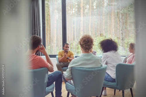 Man talking in group therapy session photo